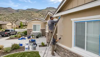Professional house painters working on exterior home repaint project in Reno NV